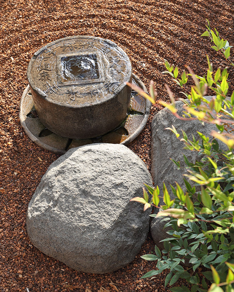 Round stone water feature on gravel in a zen garden, Young Garden Design